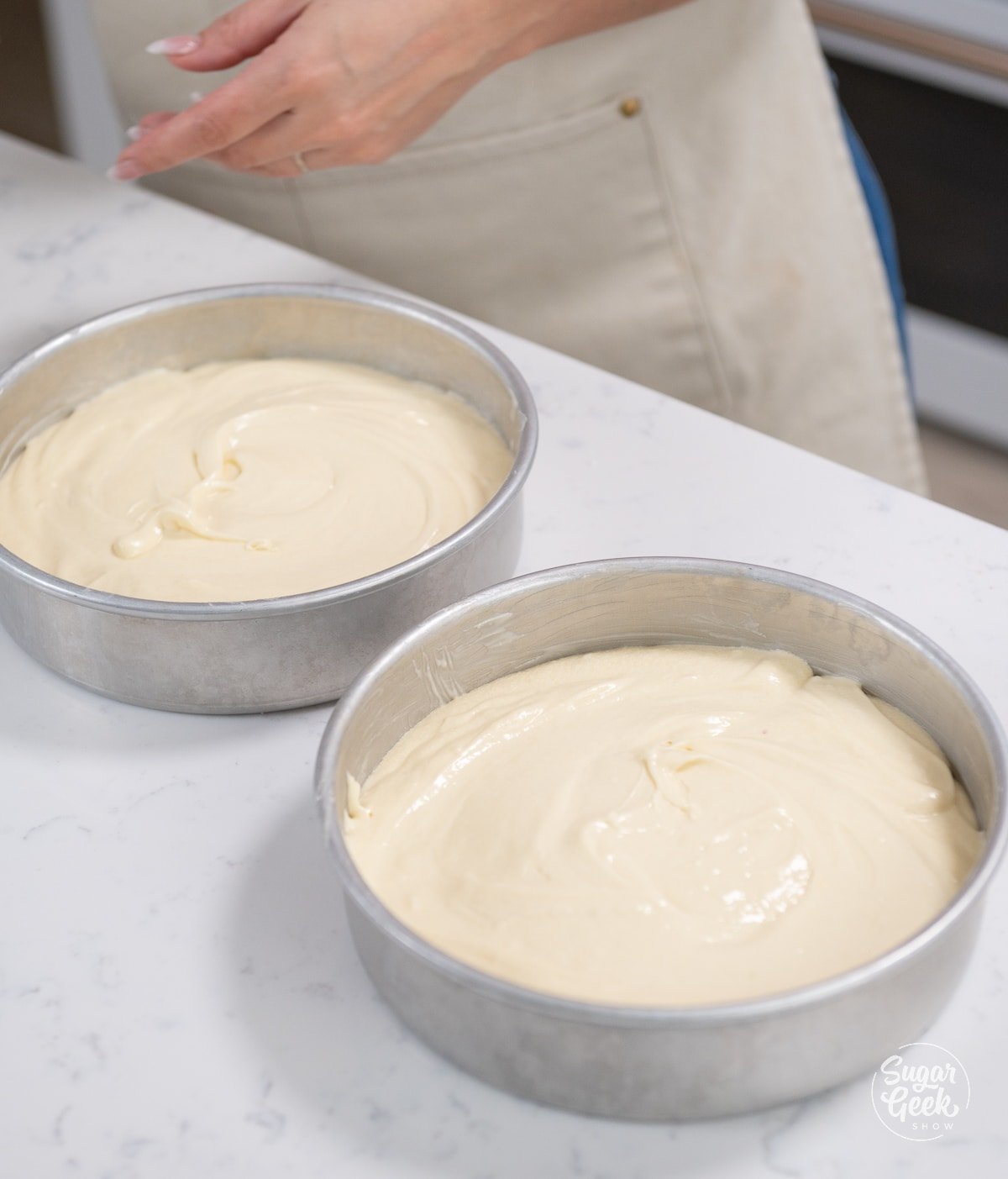 picture of two cake pans filled with cake batter.