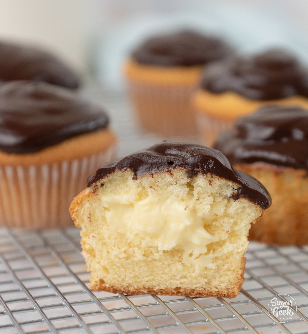 picture of Boston cream pie cupcakes with one cut in half.