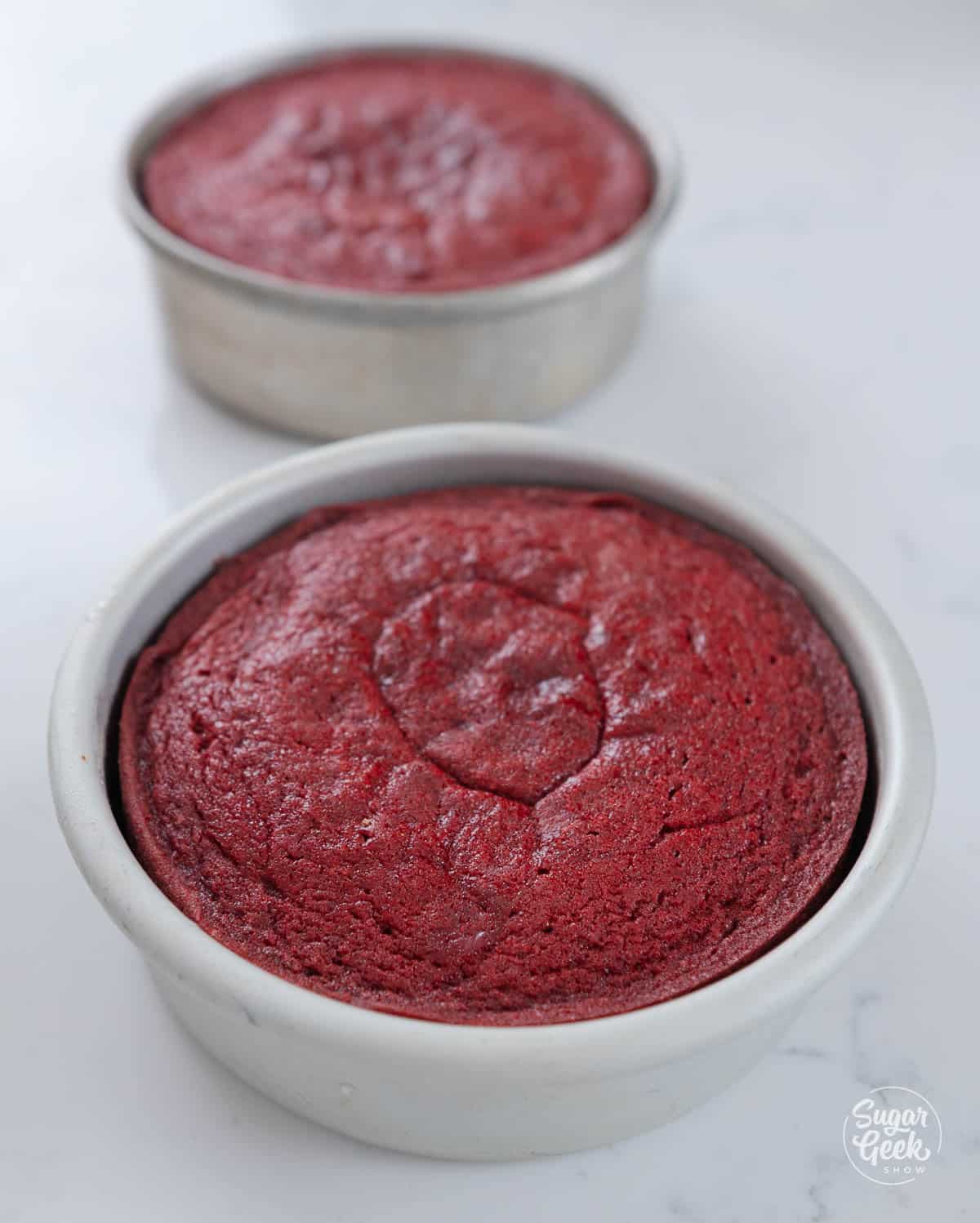 two cake pans with red velvet cake.