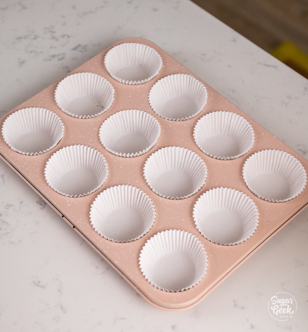 cupcake pan with white cupcake liners.