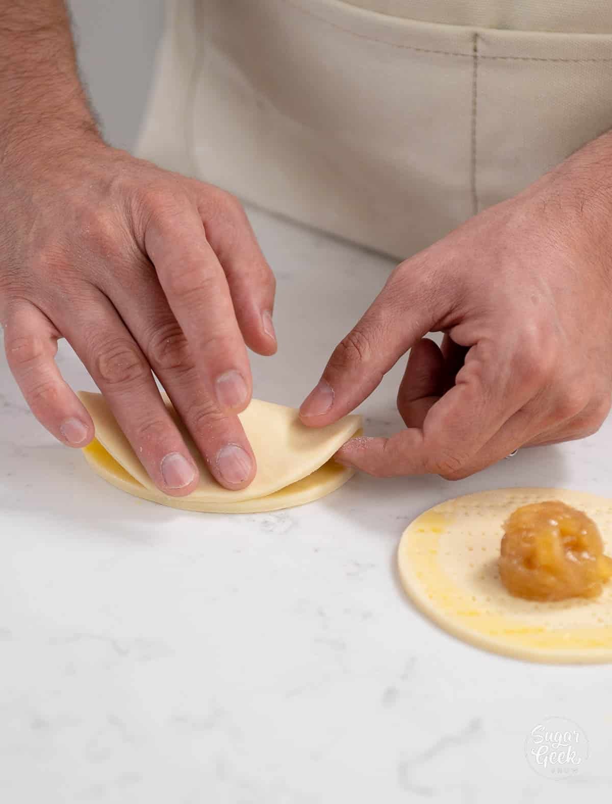 hand gently pressing the dough closed
