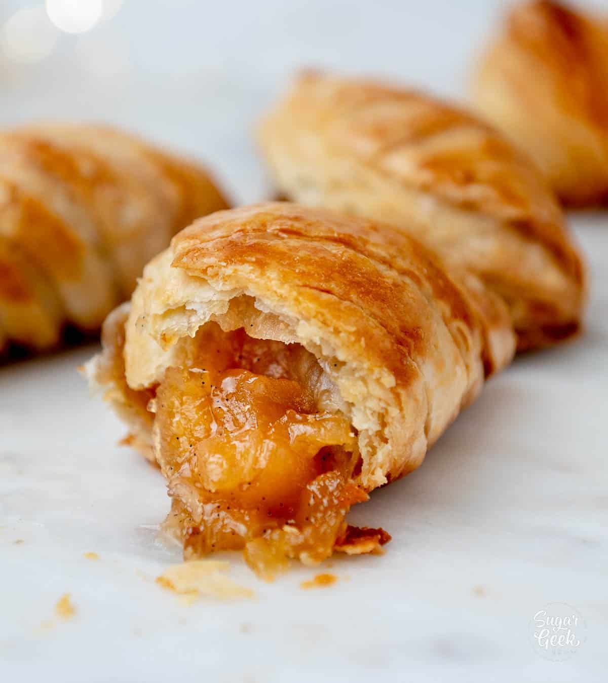 apple turnover with a bite taken. 