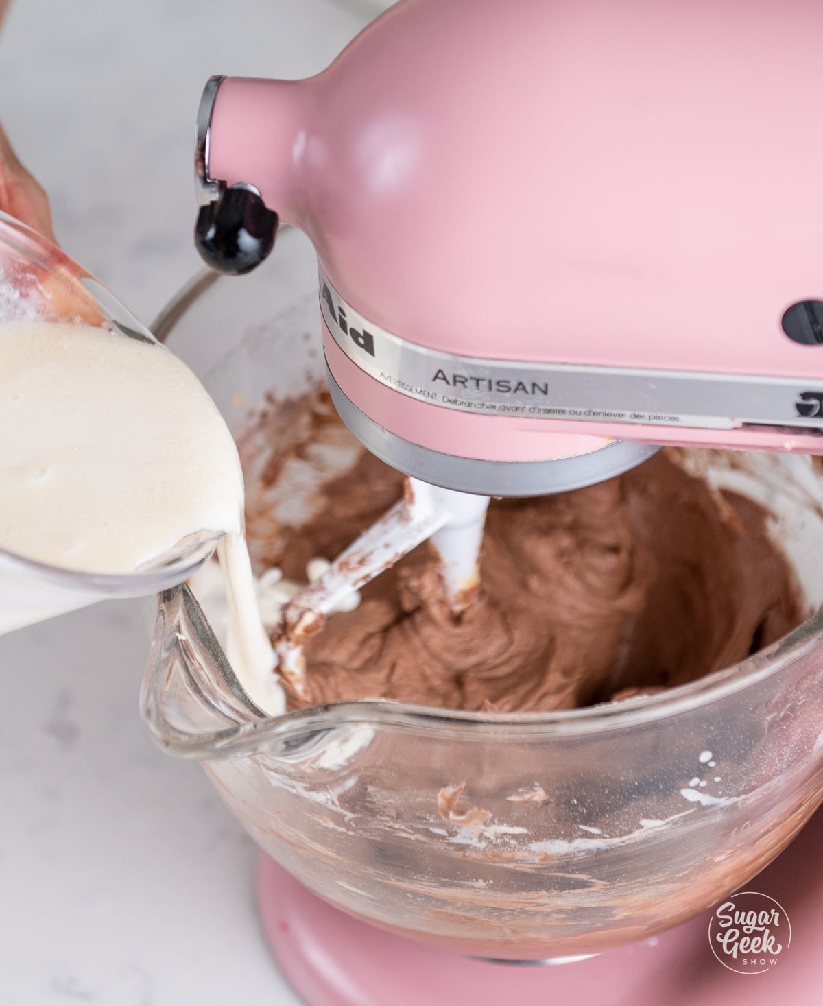 buttermilk mixture being added into the chocolate cupcake batter