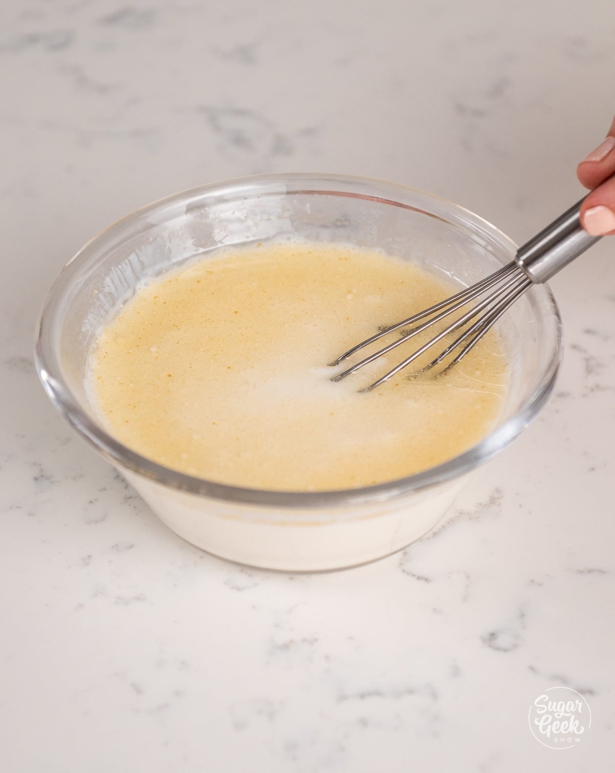buttermilk, oil, and vanilla extract in a bowl with a whisk