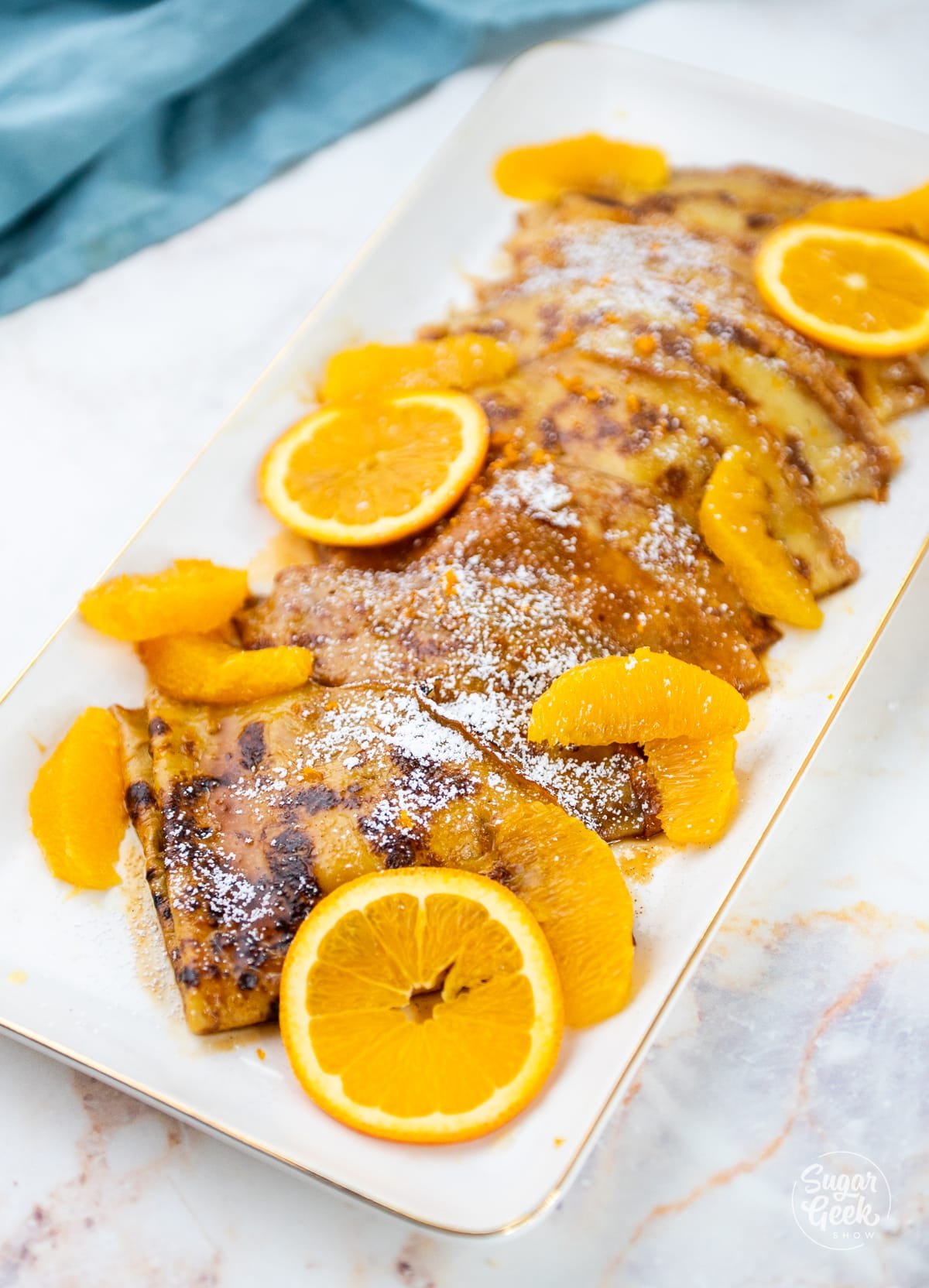 plate of crepes suzette with orange slices