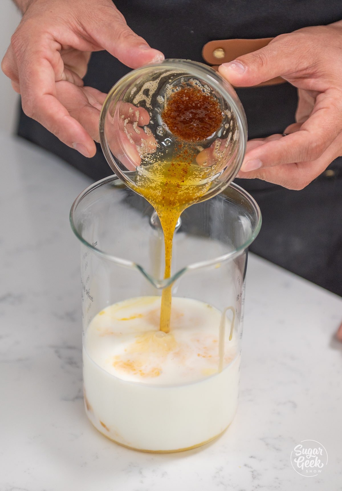 pouring crepe batter ingredients into a tall container