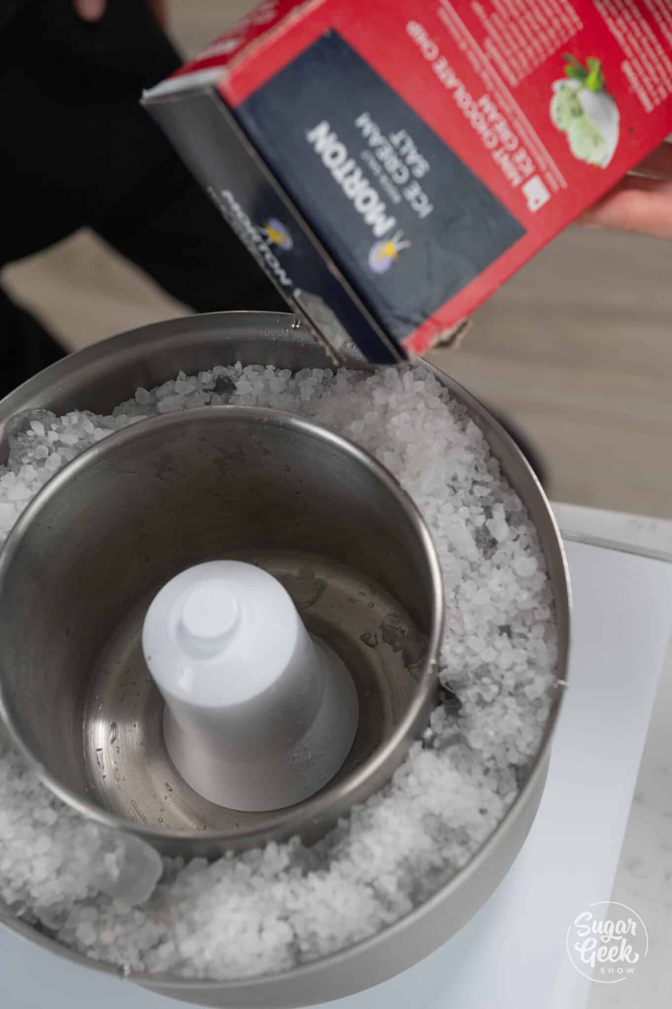 pouring ice cream salt on top of ice into an ice cream maker