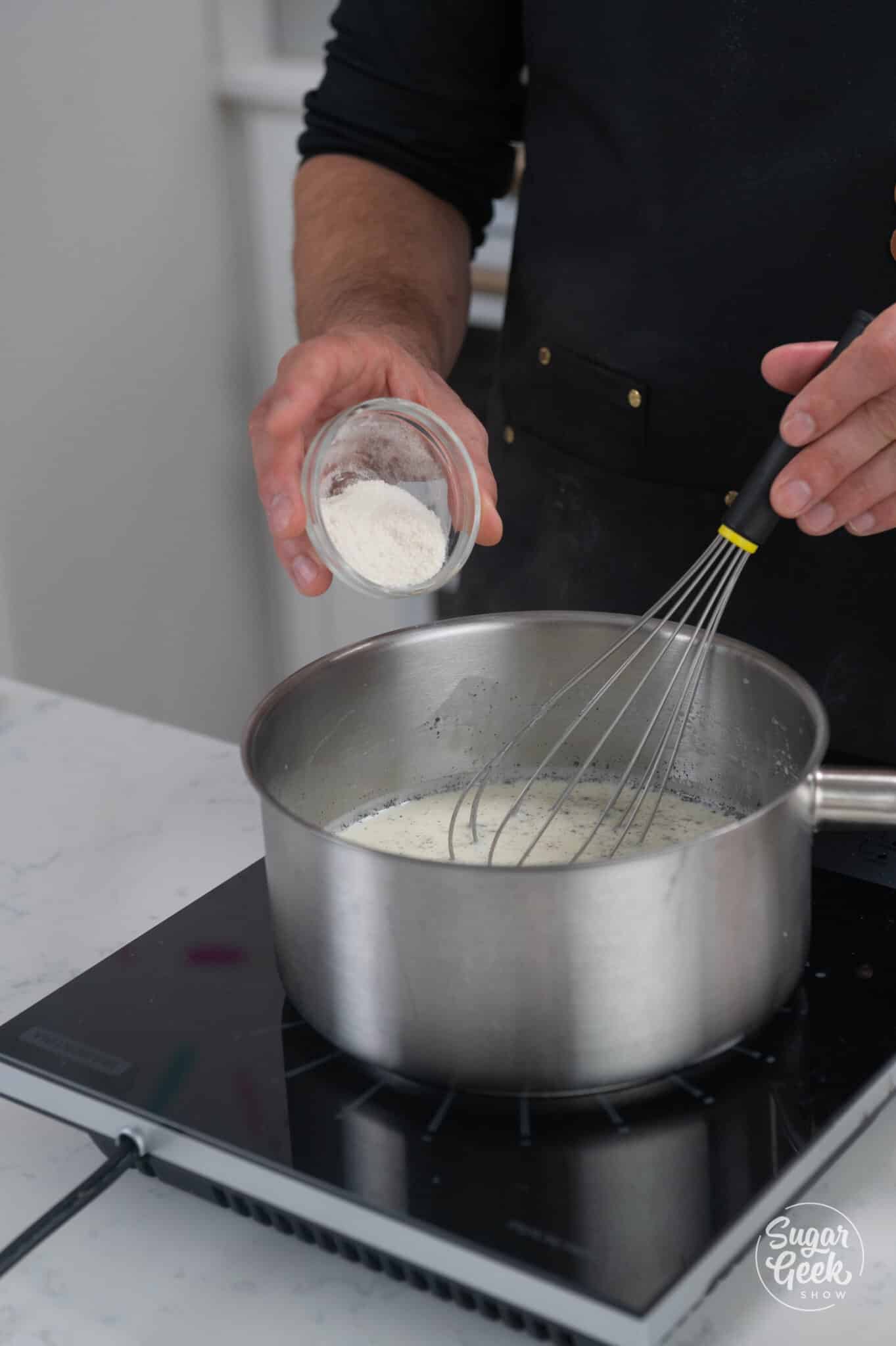 adding ice cream stabilizer to a pot of milk