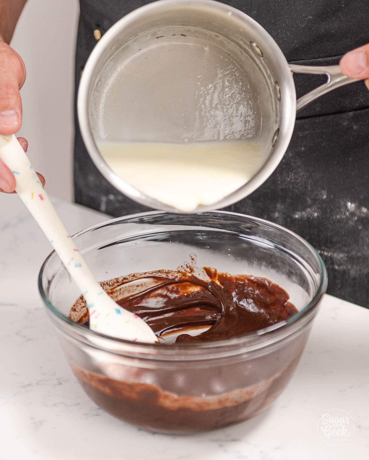 pouring second portion of cream over chocolate mixture. 