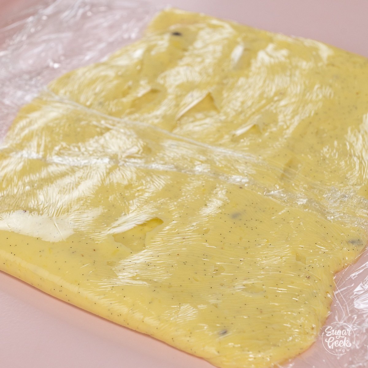 pastry cream wrapped in plastic wrap and shaped into a rectangle