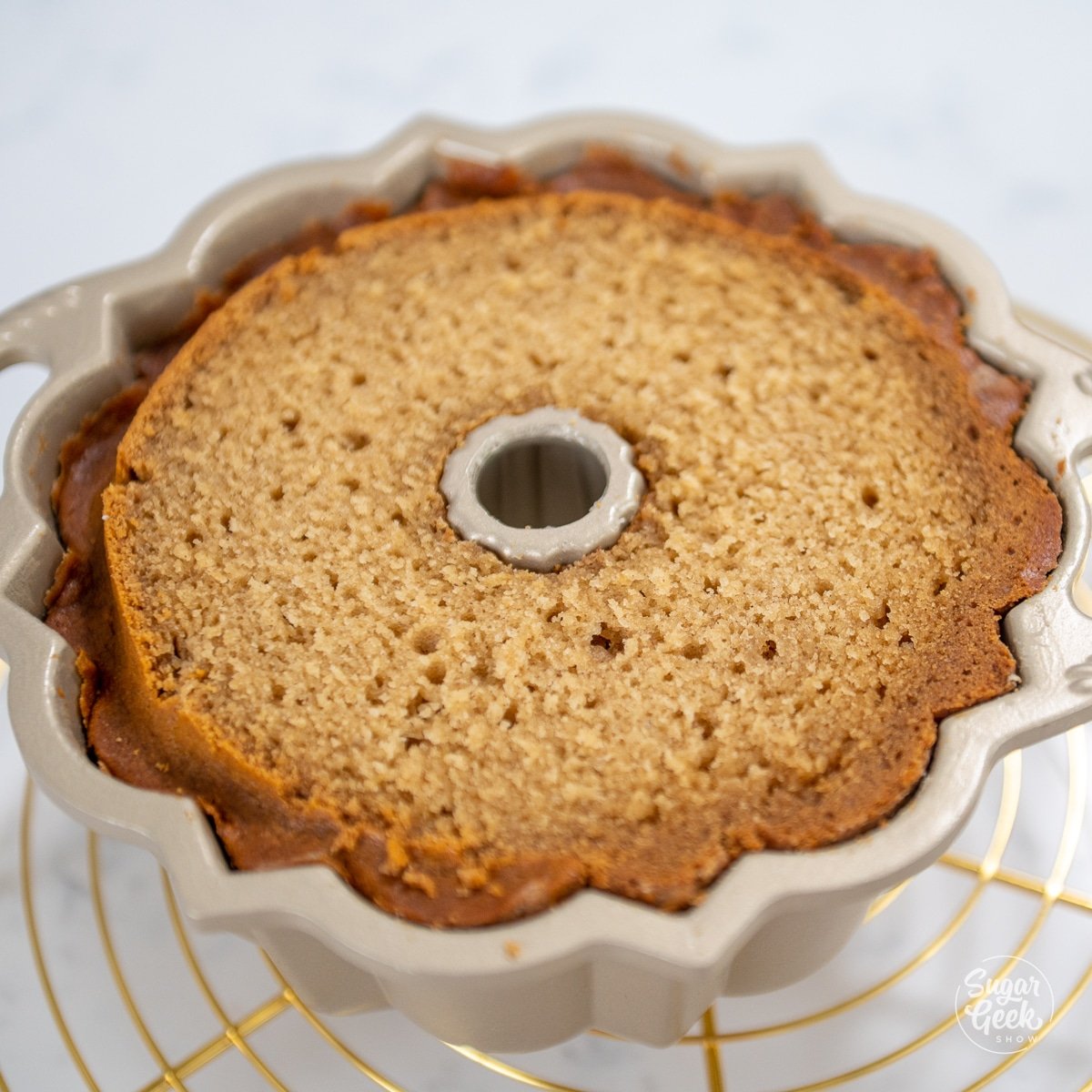 picture of honey bundt cake with dome cut off in pan. 