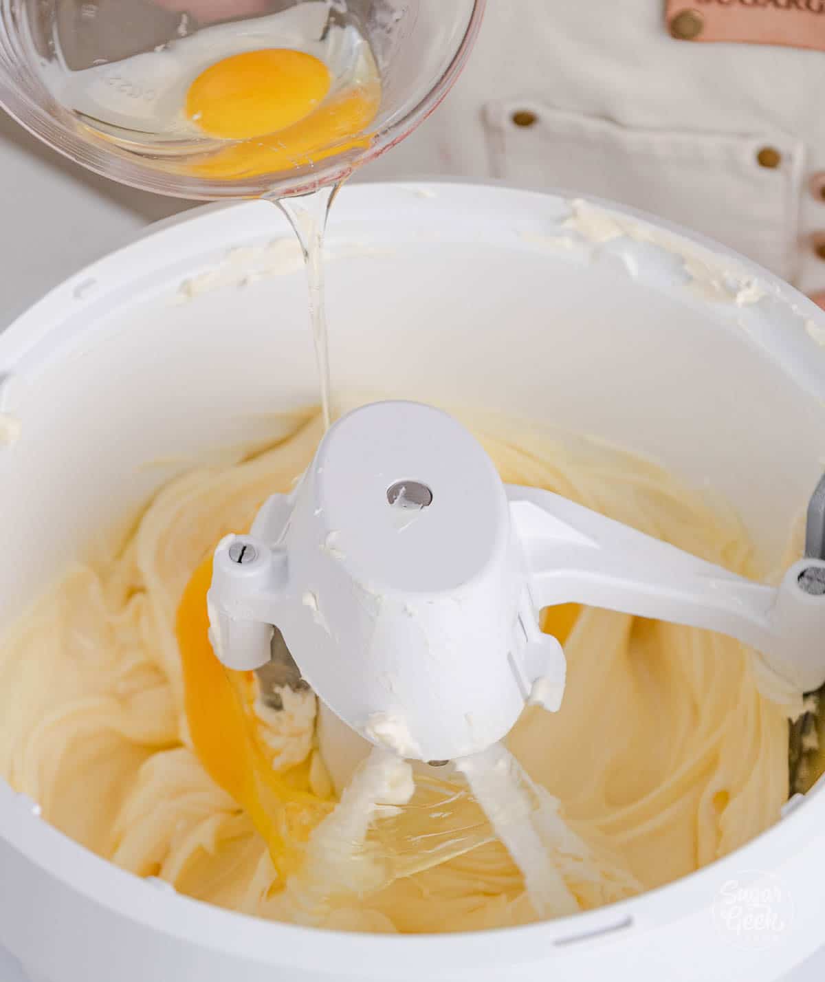 bowl of eggs being poured into a stand mixer