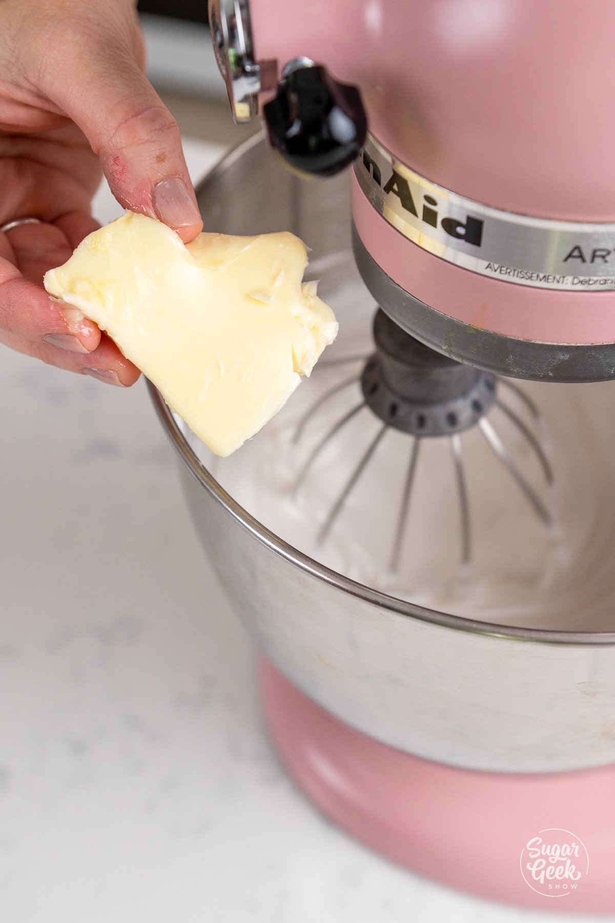 adding butter to stand mixer bowl. 