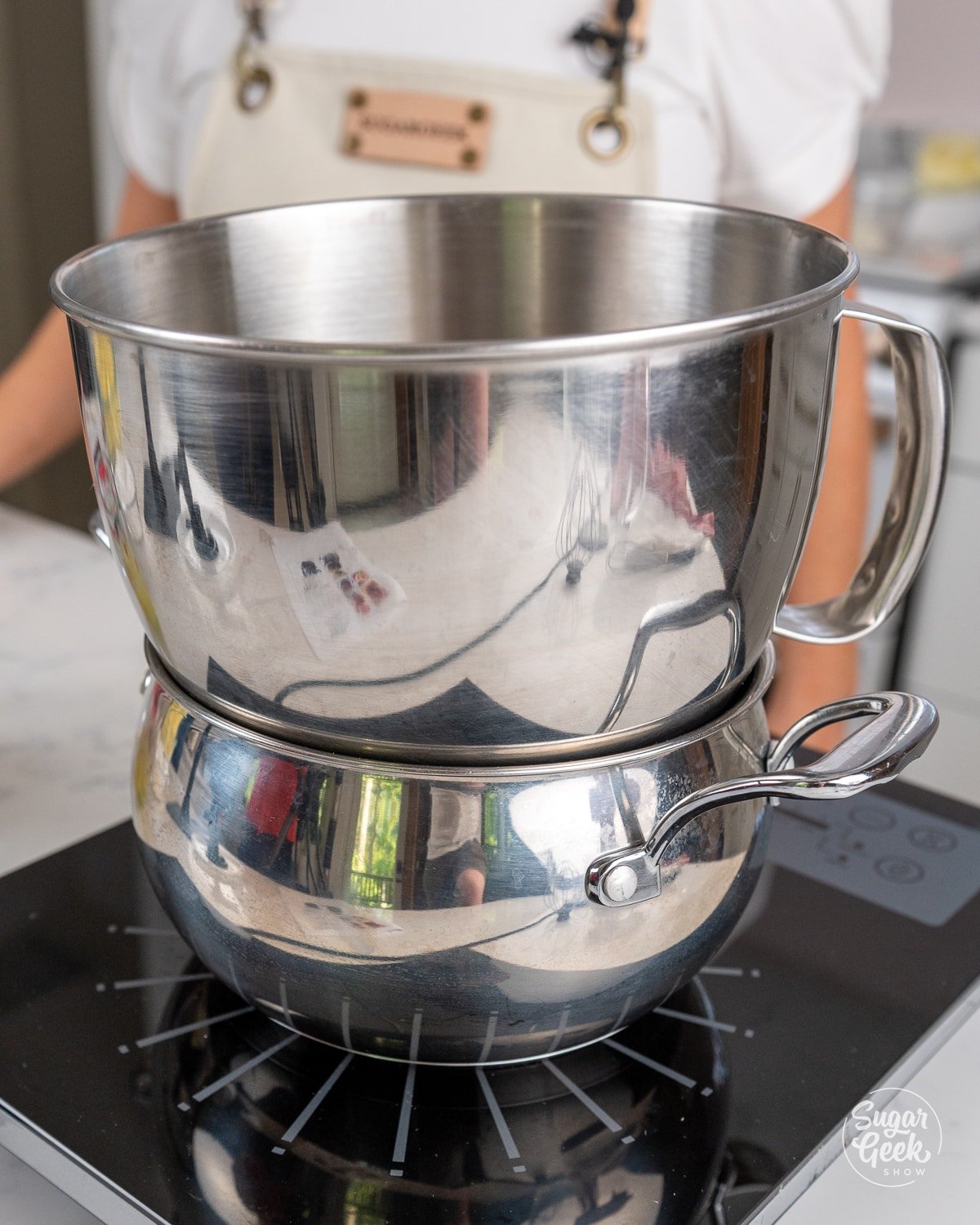 picture of a metal stand mixing bowl on top of a pot of simmering water. 