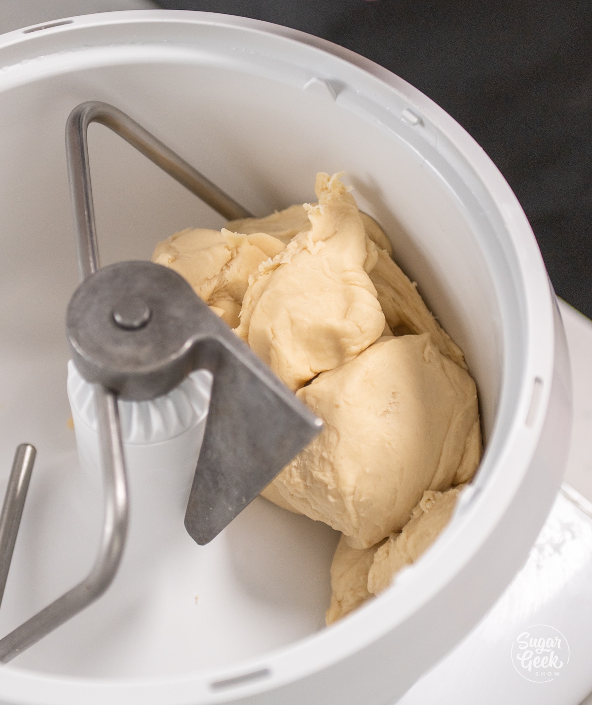 croissant dough in the white bowl of a stand mixer
