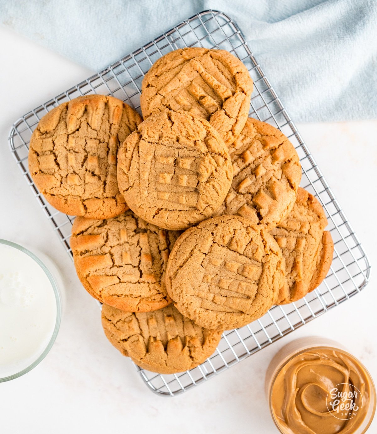 baked peanut butter cookies piled on a cooling rack