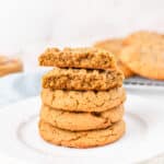 stack of peanut butter cookies with a cut open one on top