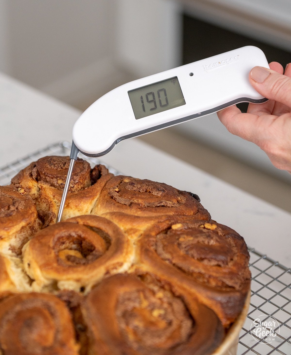 thermometer inserted in baked sticky buns reading 190 degrees