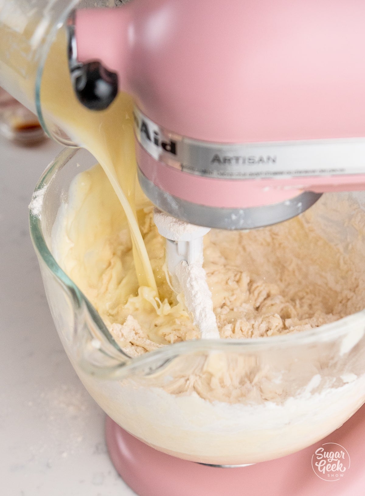 mixing liquid ingredients into dry ingredients in a stand mixer