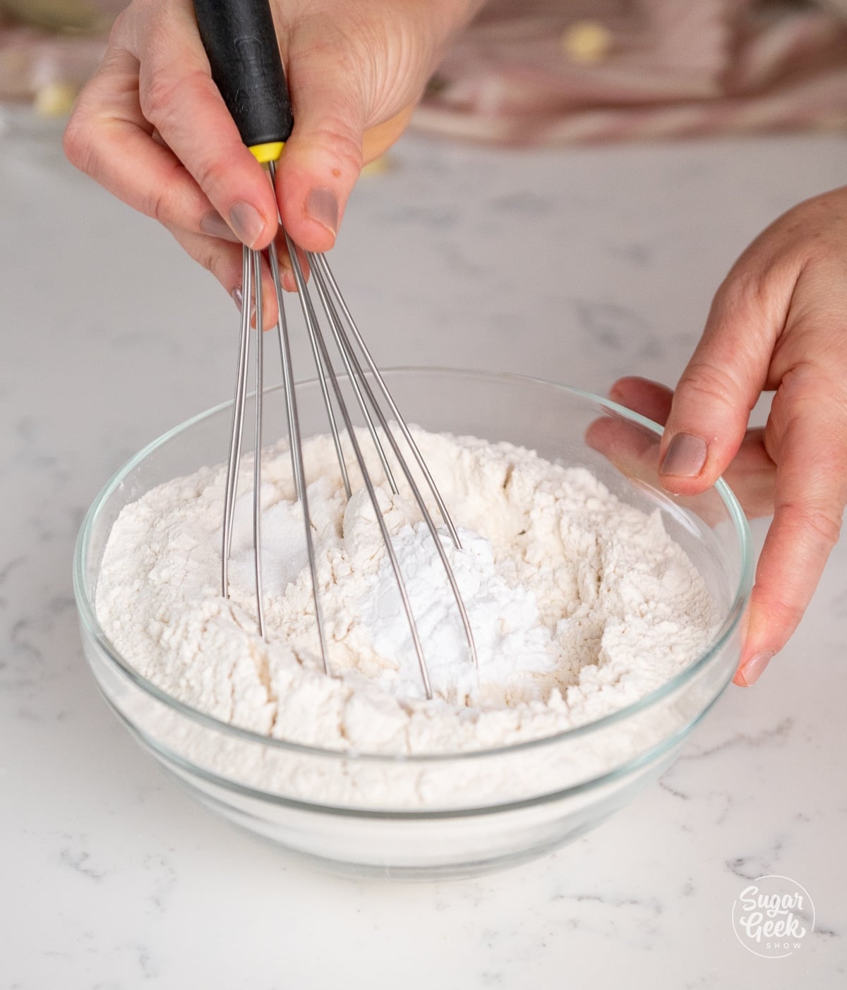 dry ingredients being whisked together in a glass bowl