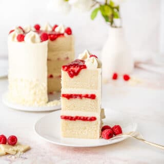slice of white chocolate raspberry cake on a plate