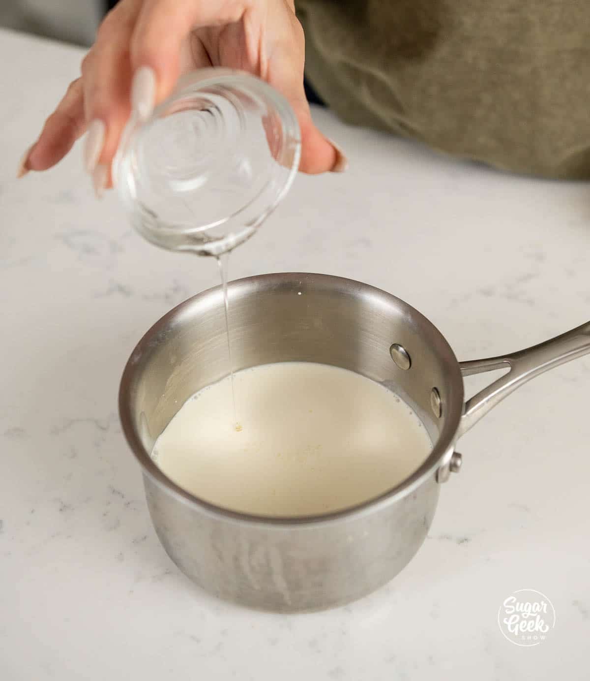 adding corn syrup to cream in a saucepan