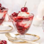 Tall glass filled with ice cream and cherries jubilee