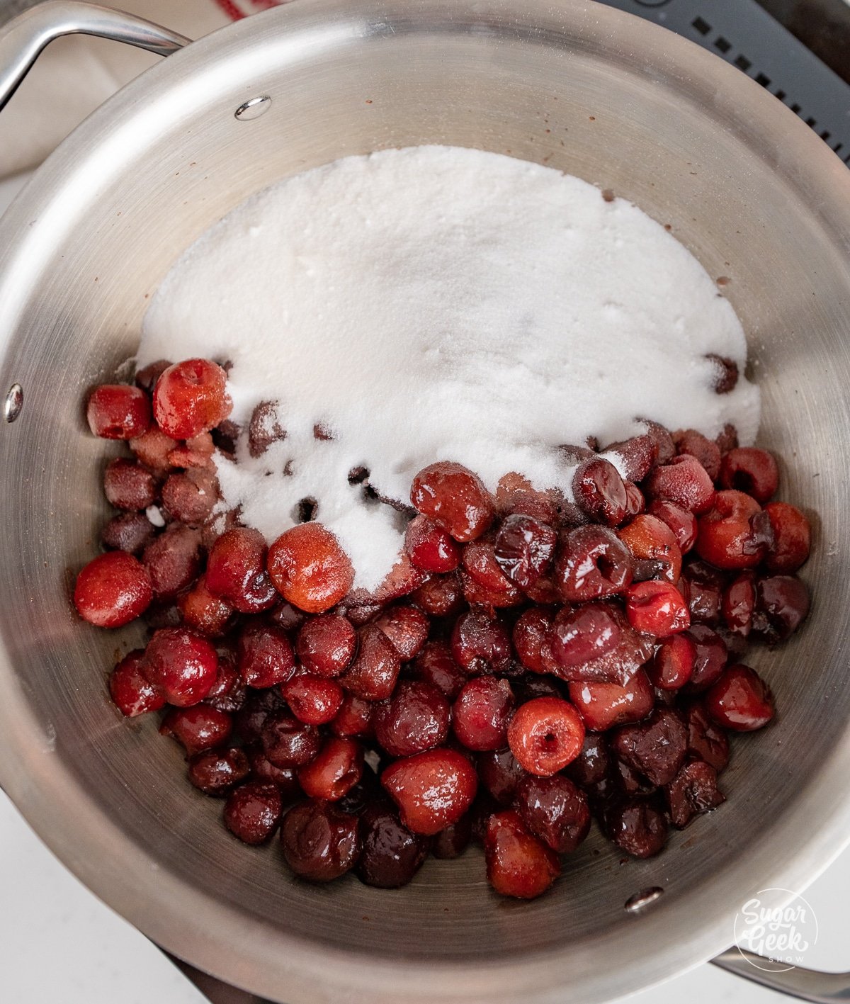 Ingredients for cherry filling in a large saucepan