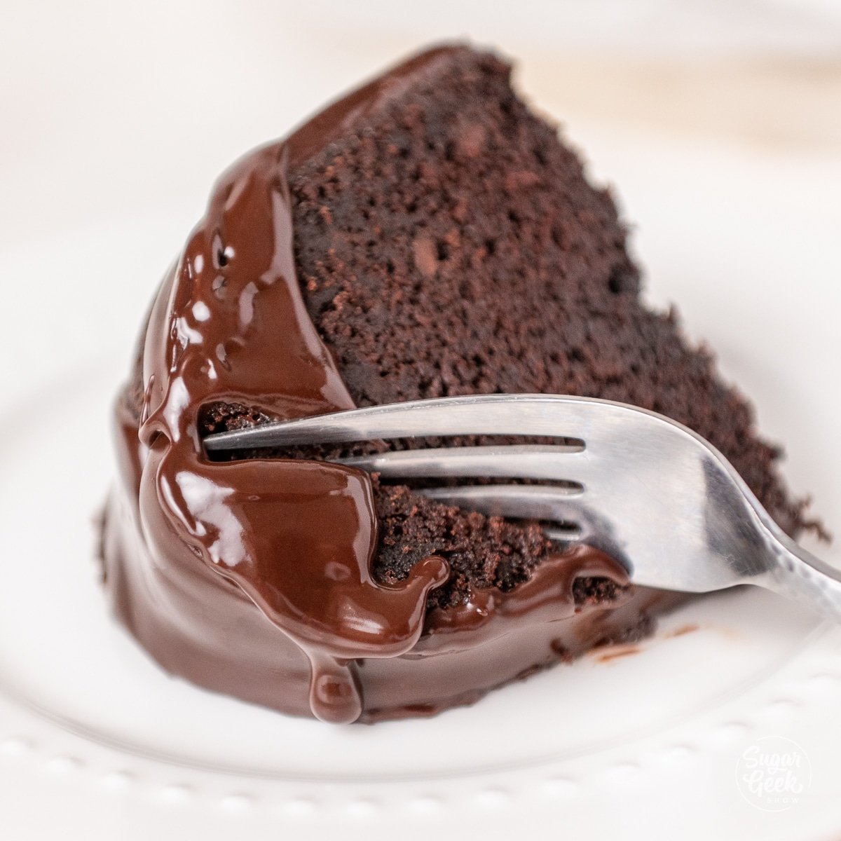 fork cutting through a slice of gooey chocolate bundt cake