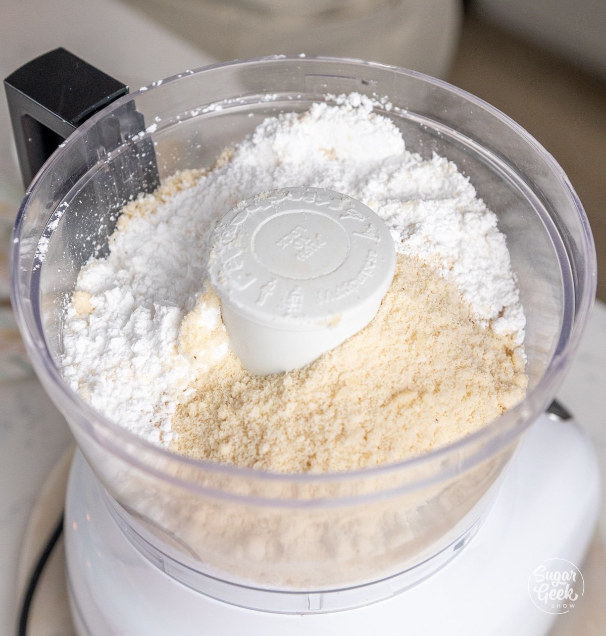 powdered sugar and almond flour in a food processor bowl