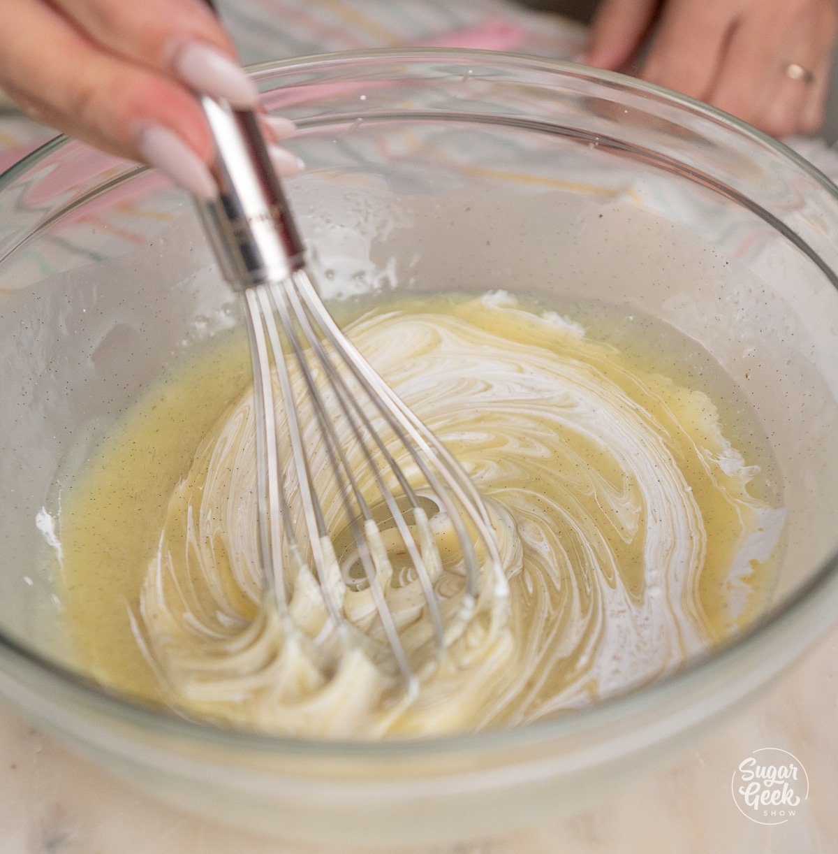 hand mixing white chocolate ganache with a whisk