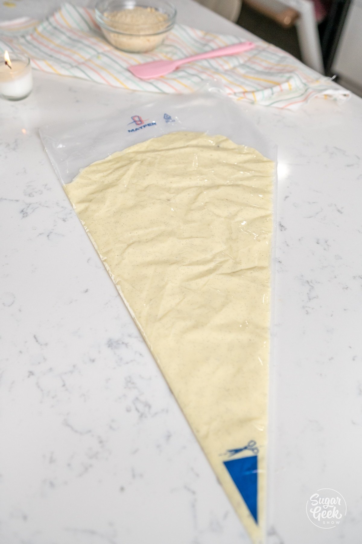 pastry bag of white chocolate ganache flat on a table