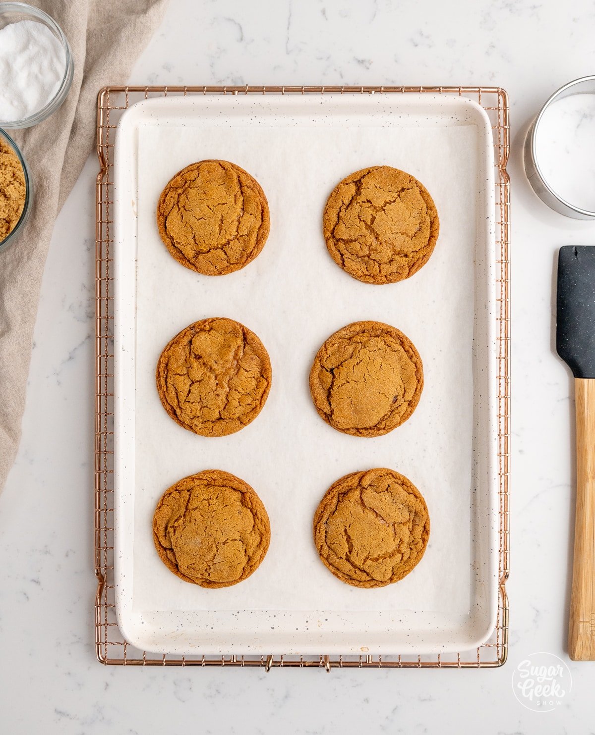 baked molasses cookies on a sheet pan