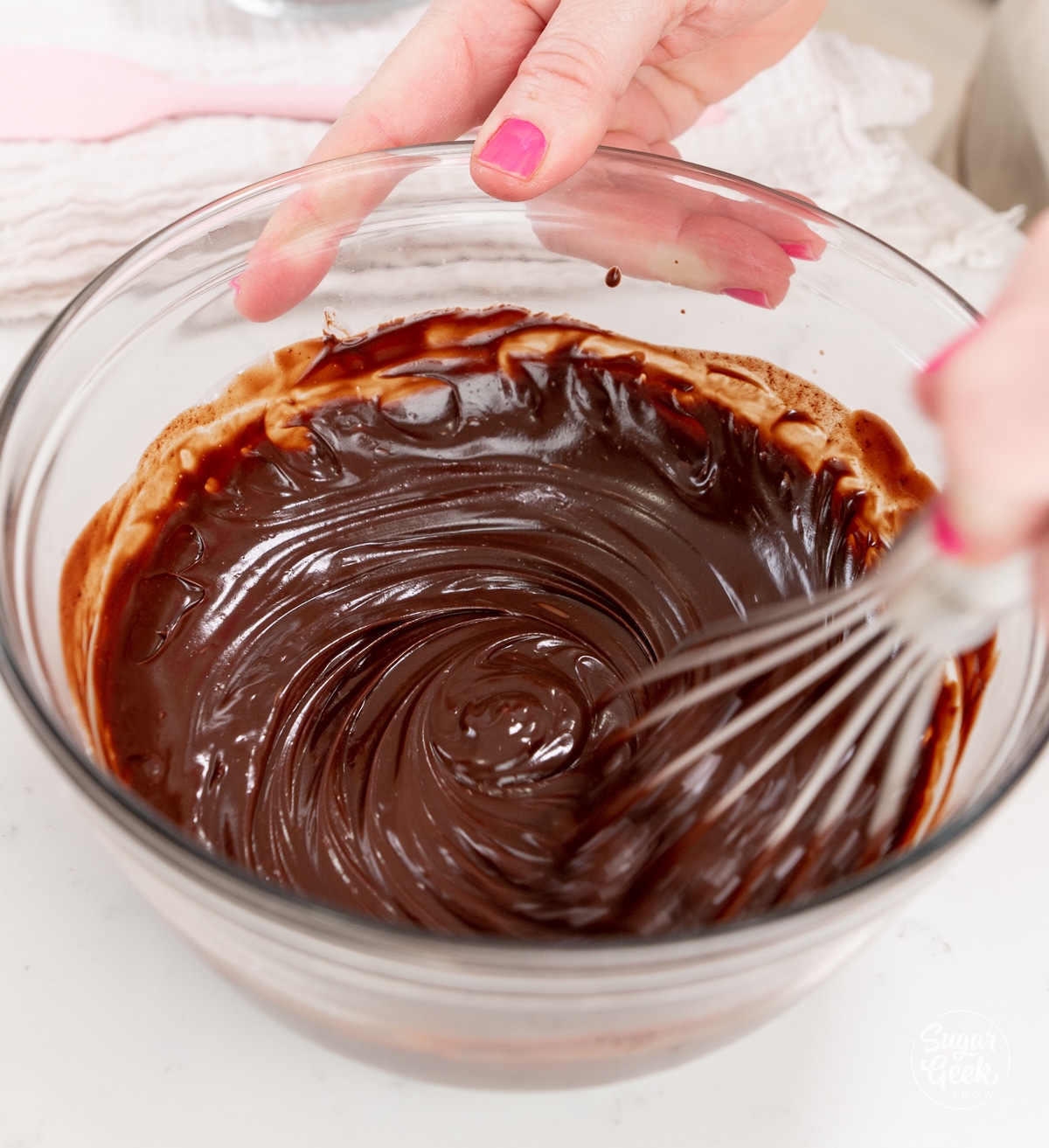 whisk mixing together ganache in a bowl