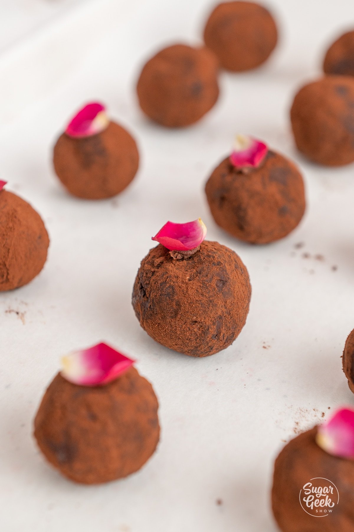 rose chocolate truffles lined on a sheet pan