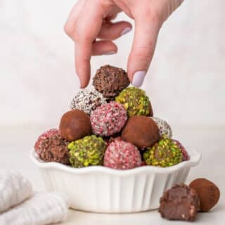 chocolate truffles in different toppings piled on a plate