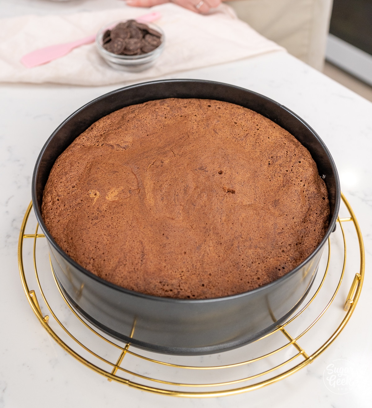 baked flourless chocolate cake in the pan on a cooling rack