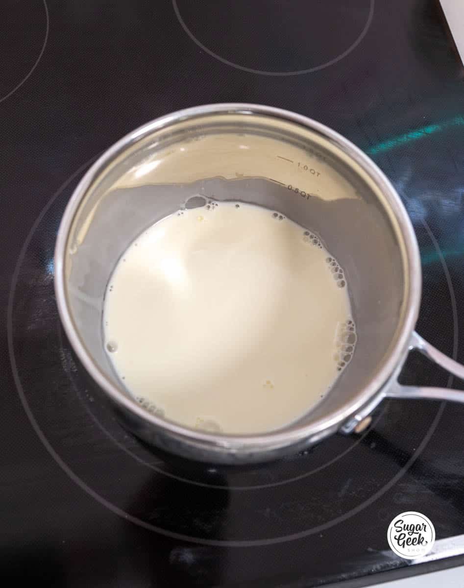 cream heating up in a pot on the stove
