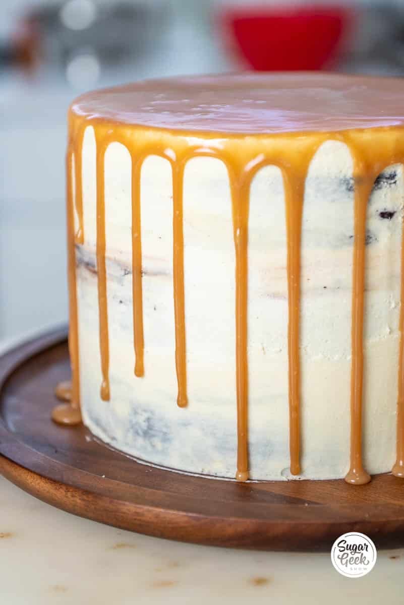 fresh caramel sauce dripping down the sides of a cake