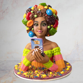 Cake sculpted to look like a woman playing Candy Crush on her phone