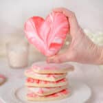 hand holding heart shaped cookies.