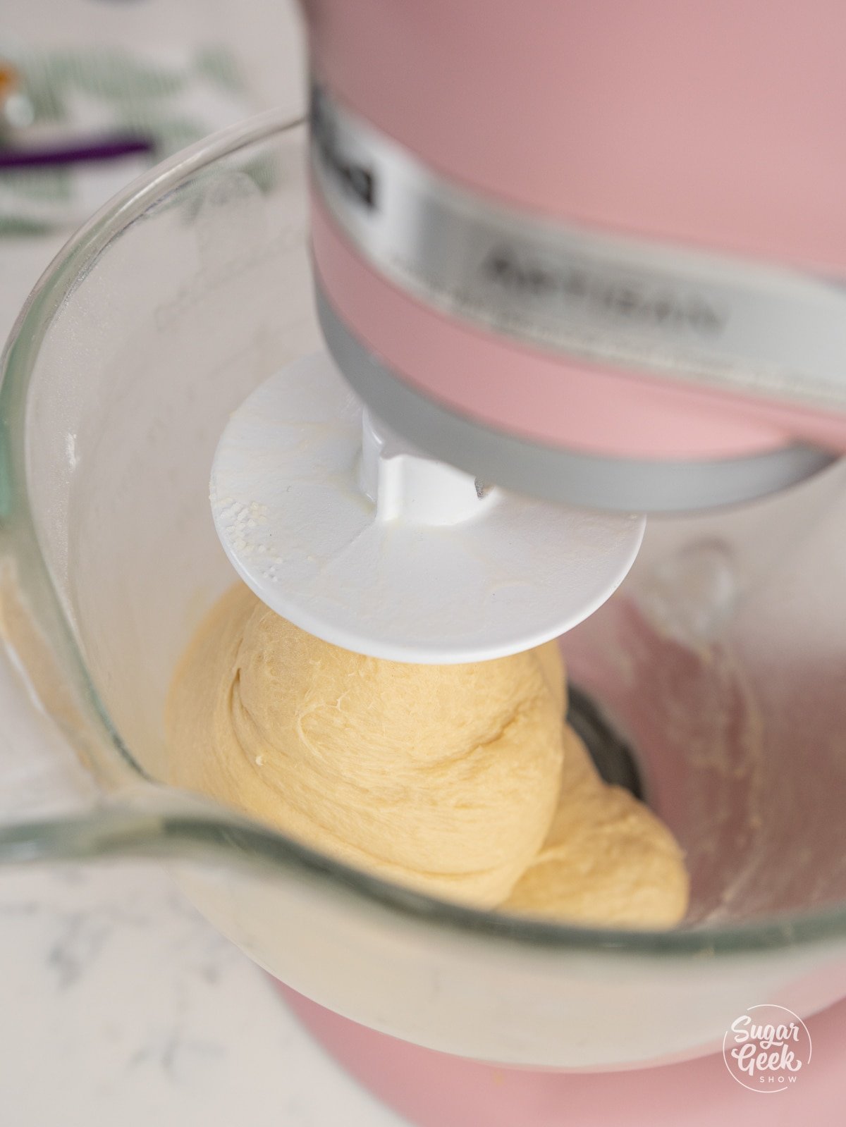 dough mixing in a glass stand mixer bowl