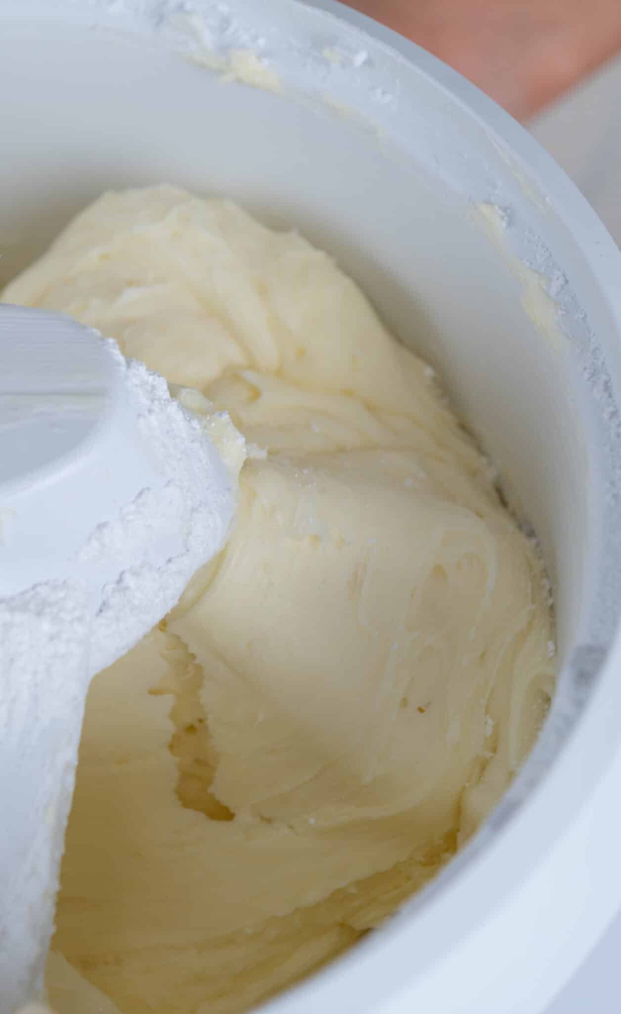 close up of cream cheese frosting in a mixer