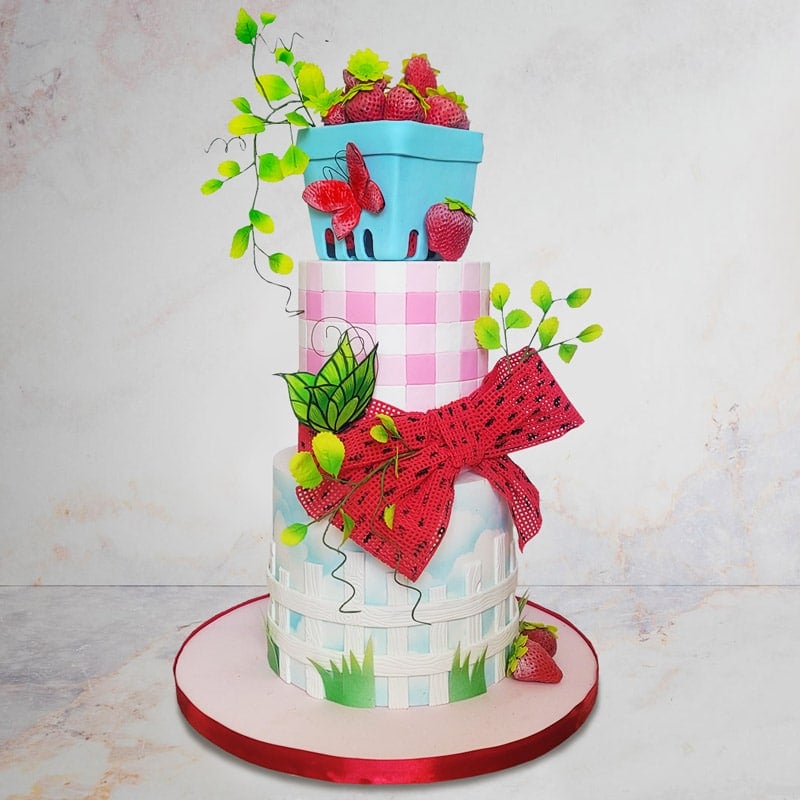 Cake sculpted and decorated to look like strawberries