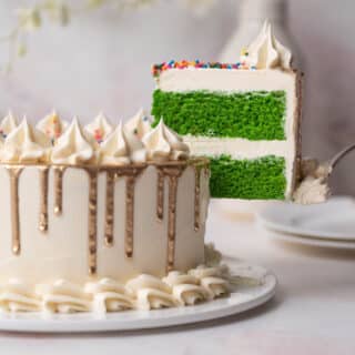 slice of green velvet cake coming out of a full cake