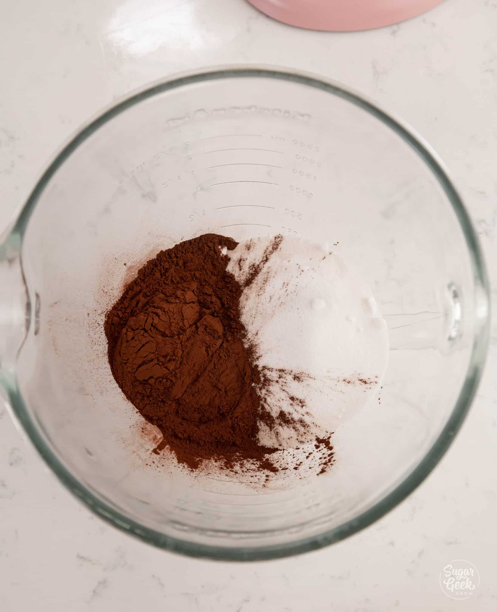 sugar and cocoa powder in a glass stand mixer bowl