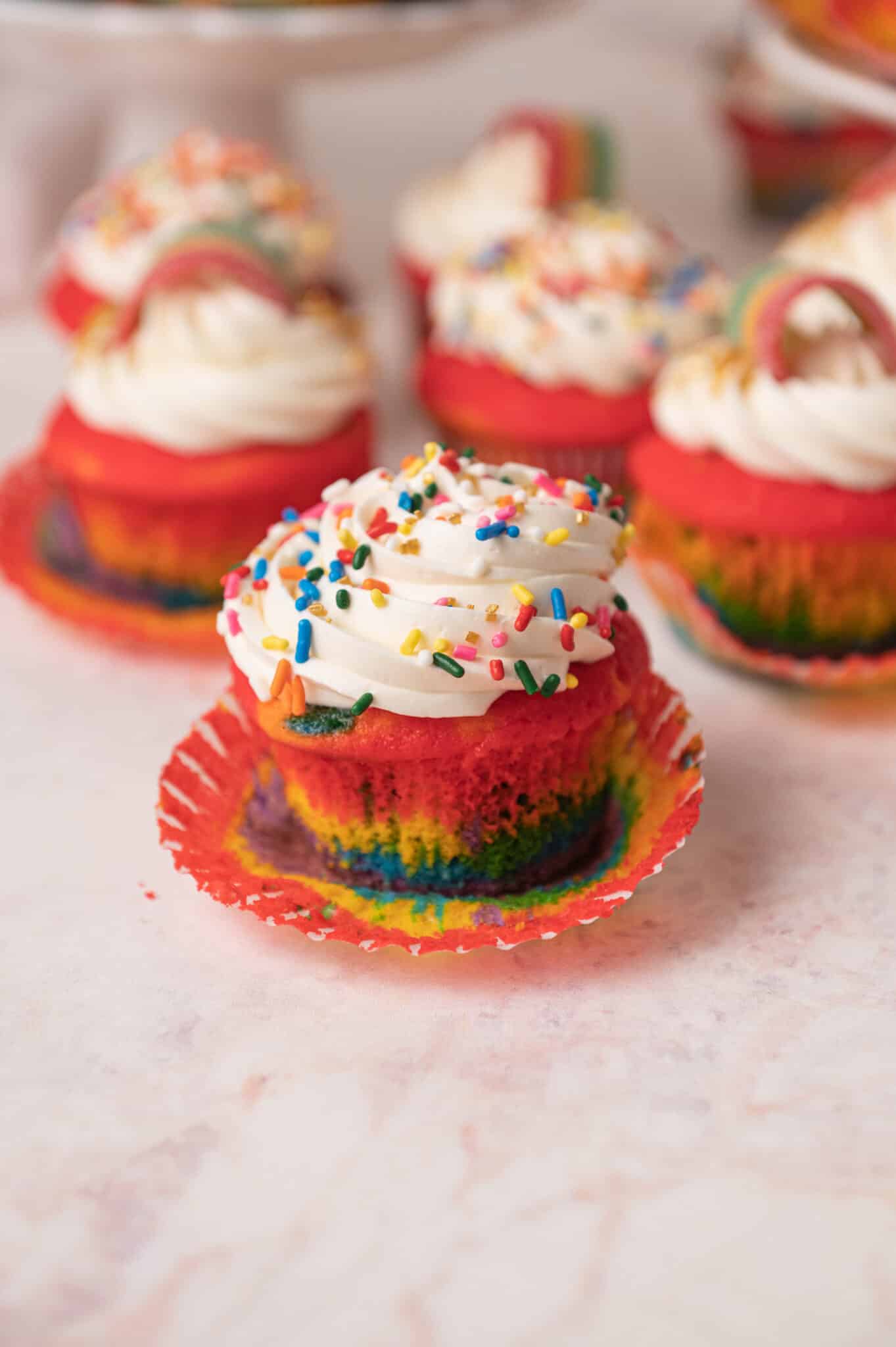 rainbow cupcake with a rainbow candy and buttercream on top