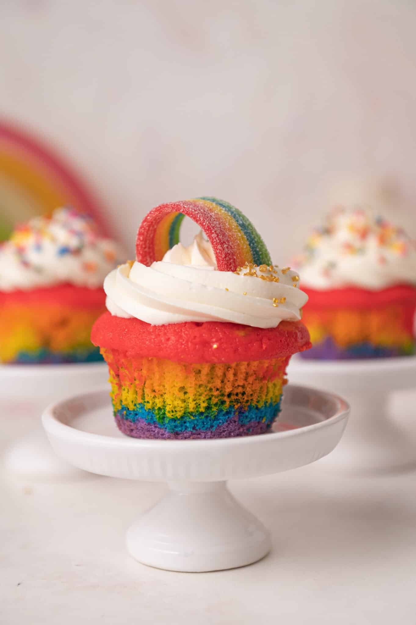 rainbow cupcake with a rainbow candy and buttercream on top