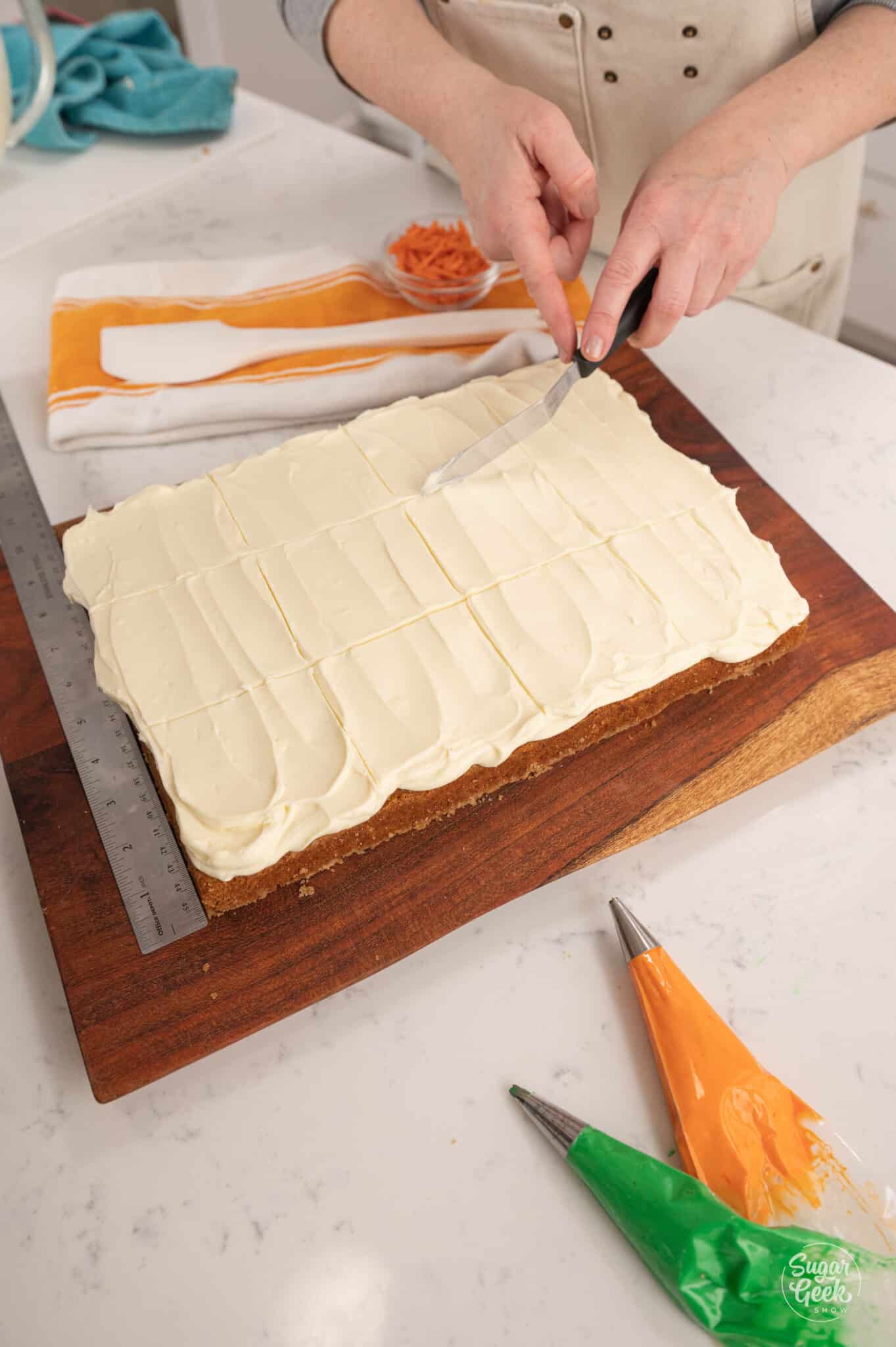 Hands scoring lines in the top of frosting