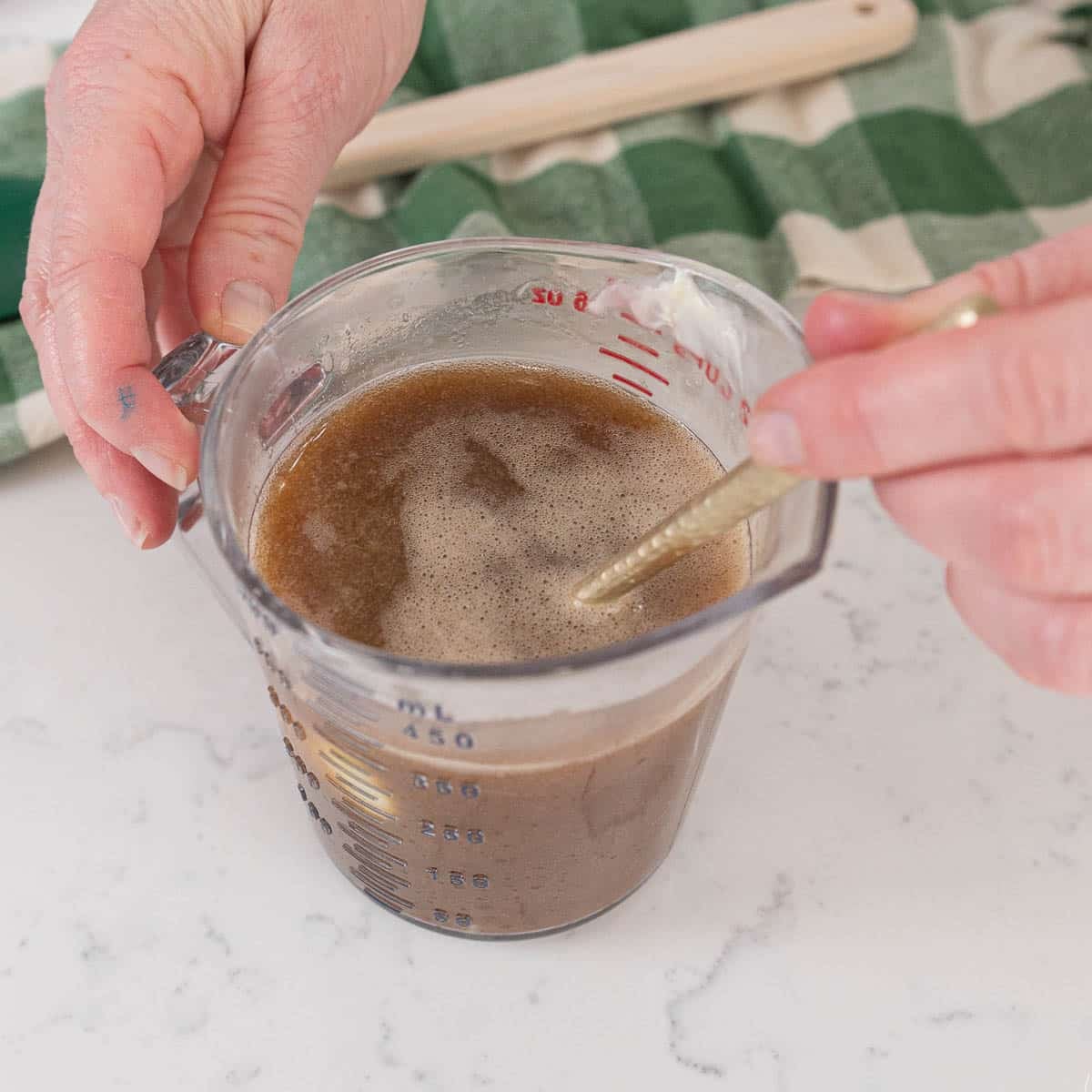mixing guinness and butter together in a measuring cup